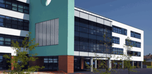 External render removal, school building, Barnet